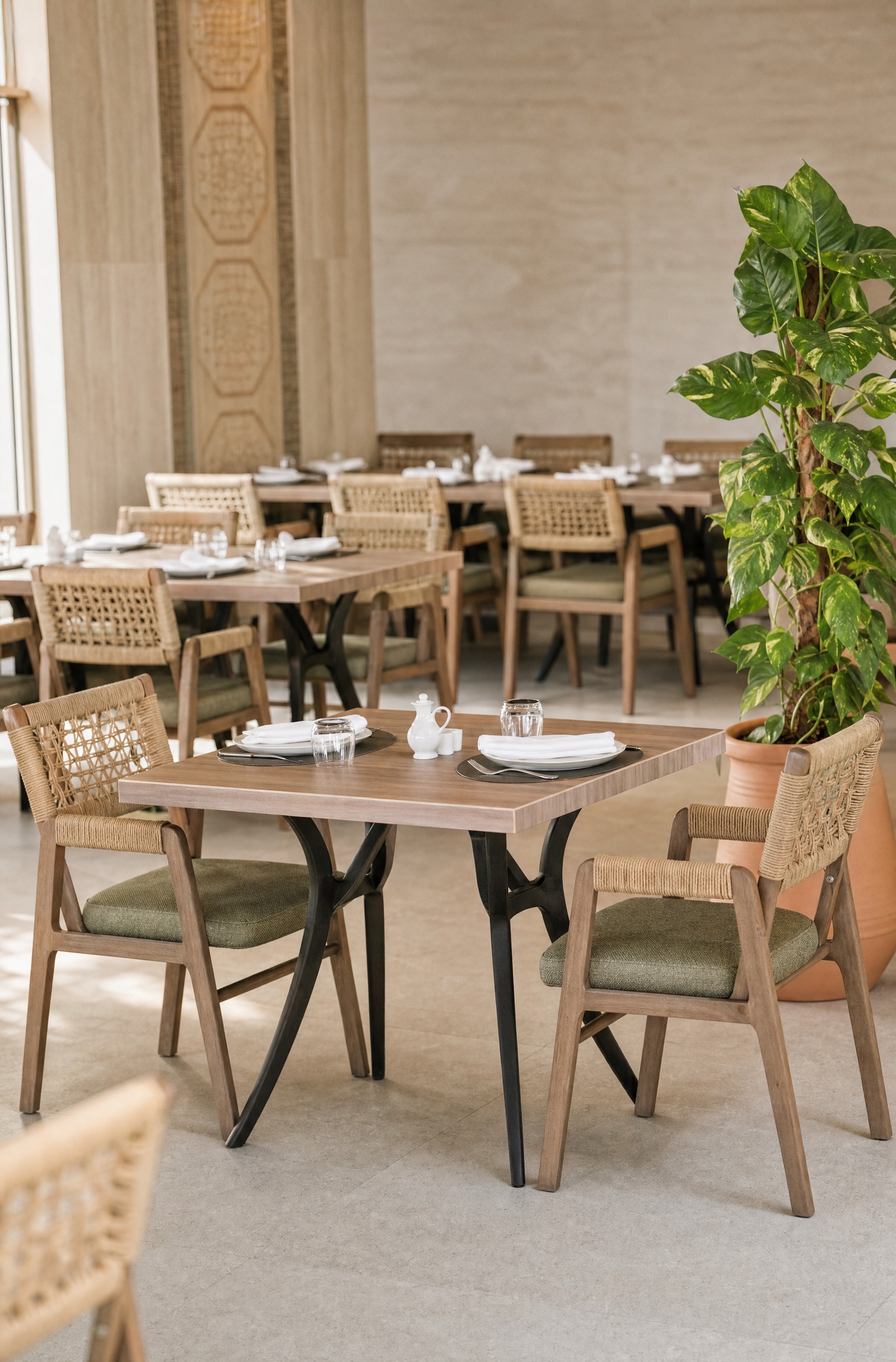 Piazza — the shaded terrace laid with woven chairs