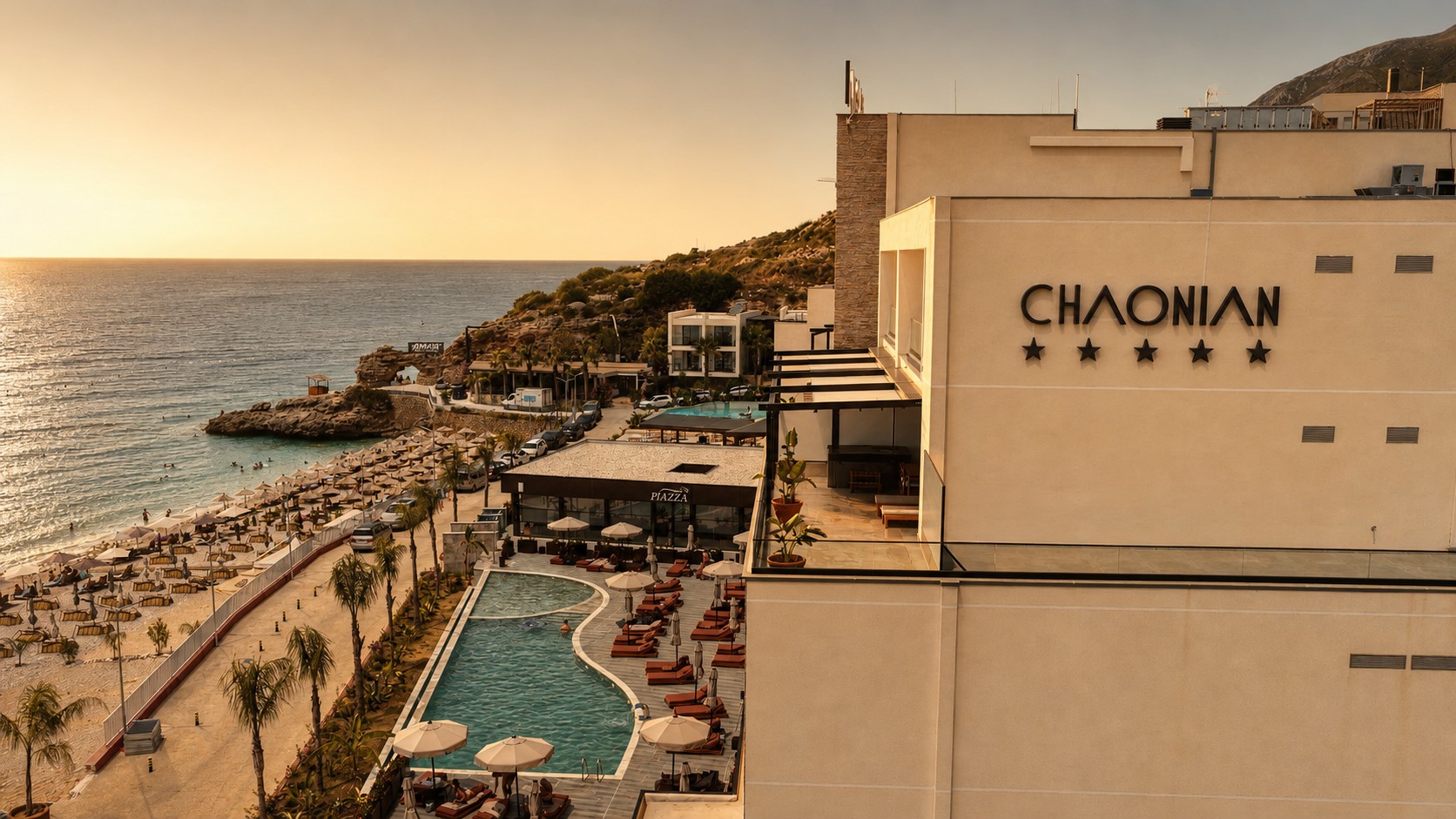 Chaonian Hotel — the hotel, pool and beach from above at golden hour